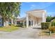 Attractive single-story home showcasing a covered carport area, a blue front door, and lush landscaping at 16602 Citrus Pkwy, Clermont, FL 34714