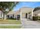 Inviting single-story home boasting a covered carport, a blue front door, and lush green lawn at 16602 Citrus Pkwy, Clermont, FL 34714