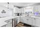 Updated kitchen featuring stainless steel appliances, white cabinetry and subway tile backsplash at 16602 Citrus Pkwy, Clermont, FL 34714