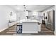Modern kitchen with white cabinets, stainless steel appliances and a large center island at 16602 Citrus Pkwy, Clermont, FL 34714