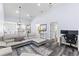 Open concept living room with views of the kitchen, featuring gray wood-look floors and recessed lighting at 16602 Citrus Pkwy, Clermont, FL 34714