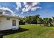 Exterior showcasing a well-maintained lawn and the rear entrance of the home at 1746 Valley Forge Road, Orlando, FL 32806