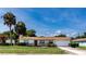 Charming single-story home featuring a well-manicured lawn and beautiful palm trees at 1746 Valley Forge Road, Orlando, FL 32806