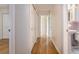 Hallway featuring hardwood floors and access to storage and a bathroom at 1746 Valley Forge Road, Orlando, FL 32806