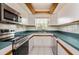 Modern kitchen features stainless steel appliances, bright white cabinets, and plenty of counter space at 1746 Valley Forge Road, Orlando, FL 32806