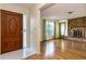 Bright living room featuring a brick fireplace, wood floors and large windows at 1746 Valley Forge Road, Orlando, FL 32806