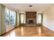 Cozy living room showcasing a brick fireplace, hardwood floors and natural lighting at 1746 Valley Forge Road, Orlando, FL 32806