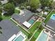 Aerial view of a home with a screened-in pool, well-maintained landscaping, and a putting green at 1850 Geronimo Trl, Maitland, FL 32751