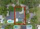 An aerial view showcases the home's layout, driveway, mature landscaping and screened in pool at 1850 Geronimo Trl, Maitland, FL 32751