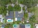 An aerial view showcases the home's layout, driveway, mature landscaping and screened in pool at 1850 Geronimo Trl, Maitland, FL 32751