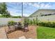 Cozy backyard patio features a charming dining set, lush greenery, and a privacy fence, creating a serene retreat at 1850 Geronimo Trl, Maitland, FL 32751