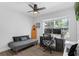 Bright bedroom with a dedicated workspace, a futon, ceiling fan and a window providing natural light at 1850 Geronimo Trl, Maitland, FL 32751