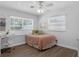 Bright bedroom with a comfortable bed, ceiling fan and desk with chair, offering a cozy retreat at 1850 Geronimo Trl, Maitland, FL 32751