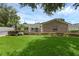 A single story home with a brick accent wall, beautifully landscaped front yard and paver driveway at 1850 Geronimo Trl, Maitland, FL 32751