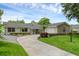 Charming single-story home featuring a well-manicured lawn and a circular driveway at 1850 Geronimo Trl, Maitland, FL 32751