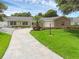 Charming single-story home with a well-manicured lawn, inviting walkway, and attached garage at 1850 Geronimo Trl, Maitland, FL 32751
