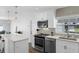Modern kitchen featuring stainless steel appliances, white cabinets, and a stylish backsplash at 1850 Geronimo Trl, Maitland, FL 32751