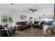 Open concept living room with modern wood-look floors, ample natural light, and comfortable leather seating at 1850 Geronimo Trl, Maitland, FL 32751