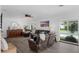 Comfortable living room with a ceiling fan, modern flooring and view of the backyard pool through the window at 1850 Geronimo Trl, Maitland, FL 32751