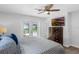 Comfortable main bedroom with French doors, a TV and chest of drawers, creating a serene living space at 1850 Geronimo Trl, Maitland, FL 32751