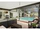 Screened-in pool with brick patio, outdoor kitchen, and lounge furniture creates a perfect entertainment space at 1850 Geronimo Trl, Maitland, FL 32751