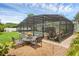 Enclosed pool area boasts a dining set, lush landscaping, and an inviting pool for luxurious outdoor living at 1850 Geronimo Trl, Maitland, FL 32751