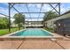 Large screened-in pool surrounded by a brick patio, green lawn, and mature trees for a serene backyard setting at 1850 Geronimo Trl, Maitland, FL 32751