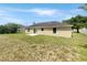 The backyard has a lawn and a patio, with the exterior of the home visible at 1877 Courtland Blvd, Deltona, FL 32738