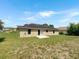 The backyard has a lawn and a patio, with the exterior of the home visible at 1877 Courtland Blvd, Deltona, FL 32738
