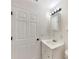 Bright bathroom featuring a white vanity, a mirrored medicine cabinet, and modern lighting fixtures at 1877 Courtland Blvd, Deltona, FL 32738