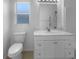Well-lit bathroom featuring a modern vanity with marble countertops and a separate toilet area at 1877 Courtland Blvd, Deltona, FL 32738