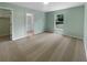 Comfortable bedroom with neutral carpet, fresh paint, and a window overlooking the yard at 1877 Courtland Blvd, Deltona, FL 32738