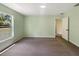 Bedroom with carpet flooring, a large window, and an open doorway to the next room at 1877 Courtland Blvd, Deltona, FL 32738