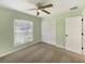 Bedroom with a closet, a window, carpet, and a ceiling fan at 1877 Courtland Blvd, Deltona, FL 32738