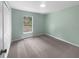 Cozy bedroom featuring neutral walls, soft carpeting, and a window providing natural light at 1877 Courtland Blvd, Deltona, FL 32738