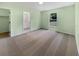 Bright bedroom with carpet flooring, a window overlooking the yard, and ensuite bathroom access at 1877 Courtland Blvd, Deltona, FL 32738