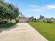 Charming single-story home with a well-manicured lawn and a long driveway at 1877 Courtland Blvd, Deltona, FL 32738