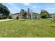 Charming single-story home with a well-manicured lawn and a bright blue front door at 1877 Courtland Blvd, Deltona, FL 32738
