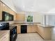 Well-lit kitchen with modern appliances, tile floors, and a bright window overlooking the yard at 1877 Courtland Blvd, Deltona, FL 32738