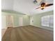 Spacious living room with a ceiling fan, carpet flooring, and ample natural light from the windows at 1877 Courtland Blvd, Deltona, FL 32738