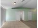 The living room features neutral paint, two closets, an arched doorway, and tile-carpet flooring at 1877 Courtland Blvd, Deltona, FL 32738