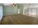 Spacious living room area with natural light and carpet flooring, leading into the kitchen area at 1877 Courtland Blvd, Deltona, FL 32738