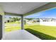 View of the back porch showcasing the lush green yard and neighborhood homes at 200 Garnet Ave, Kissimmee, FL 34758