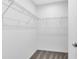 Carpeted walk-in closet with white wire shelving to maximize storage at 200 Garnet Ave, Kissimmee, FL 34758