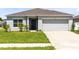 Charming single-story home with a well-maintained lawn and attached two-car garage at 200 Garnet Ave, Kissimmee, FL 34758