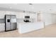 Modern kitchen featuring stainless steel appliances, white cabinets, and a spacious center island at 200 Garnet Ave, Kissimmee, FL 34758
