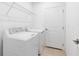 Laundry room with tile floors, washer and dryer, and wire shelving at 200 Garnet Ave, Kissimmee, FL 34758