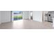 Bright and airy living room featuring tile flooring, patio access, and adjacent kitchen at 200 Garnet Ave, Kissimmee, FL 34758