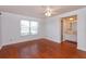 Comfortable bedroom with wood floors, a ceiling fan, and a large window at 200 Saint Andrews Blvd # 2607, Winter Park, FL 32792