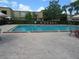 Relax and unwind at the community pool, featuring brick pavers, sun loungers, and lush hedges for privacy at 200 Saint Andrews Blvd # 2607, Winter Park, FL 32792